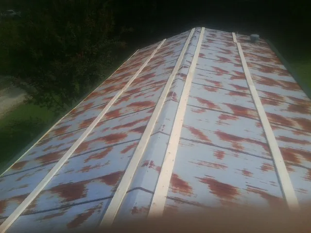 Rusted metal roof panels with new wood purlins before replacement — Storm Damage Roof Repair in Bernville by Roofing Brothers
