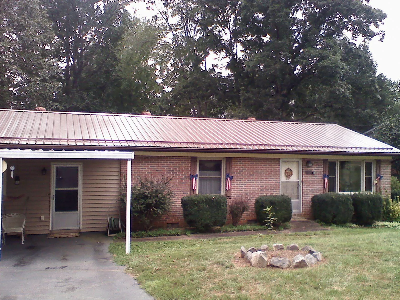 Bronze metal roof and carport on a brick ranch home — Roof Repair work by our crew in Bernville