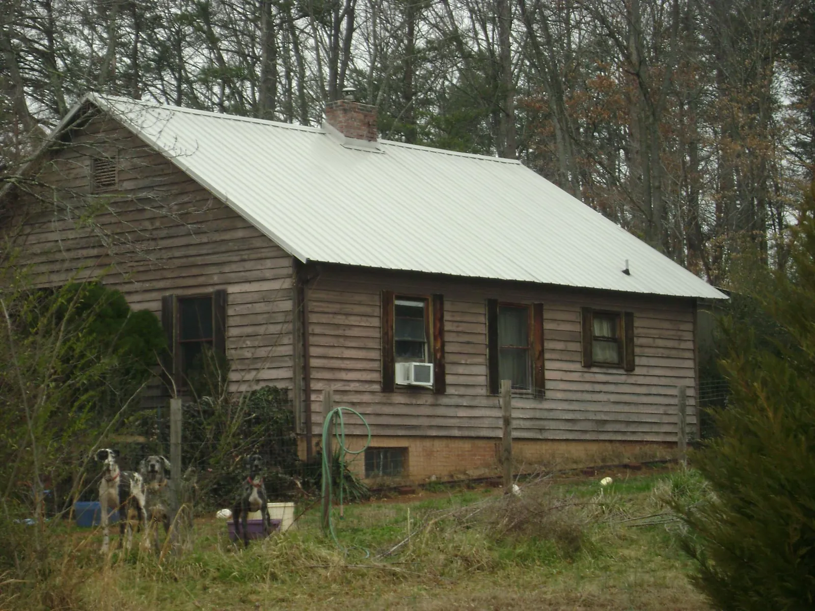 White metal roof on an old wood sided farmhouse, from a Metal Roof Installation job in Bernville